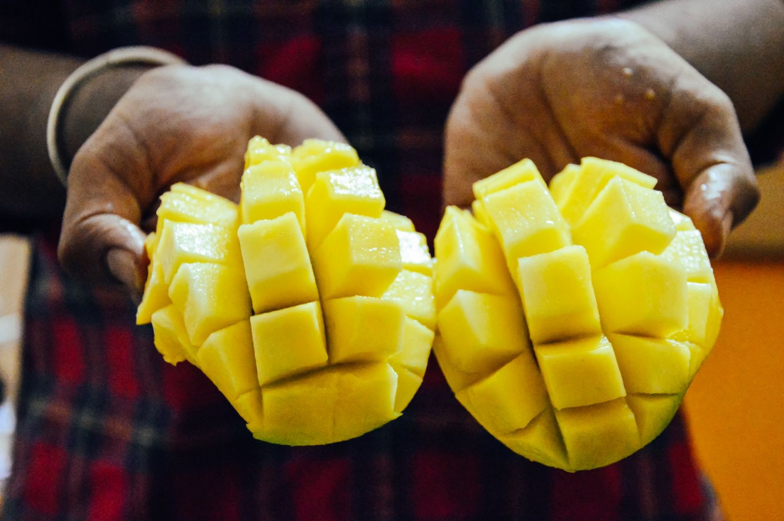 Sliced mango being held
