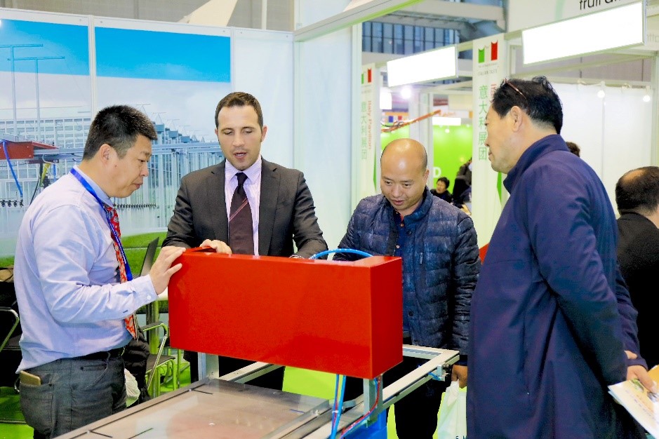 Davide Barotti of Urbinati shows a model of a seeding machine to potential customers.